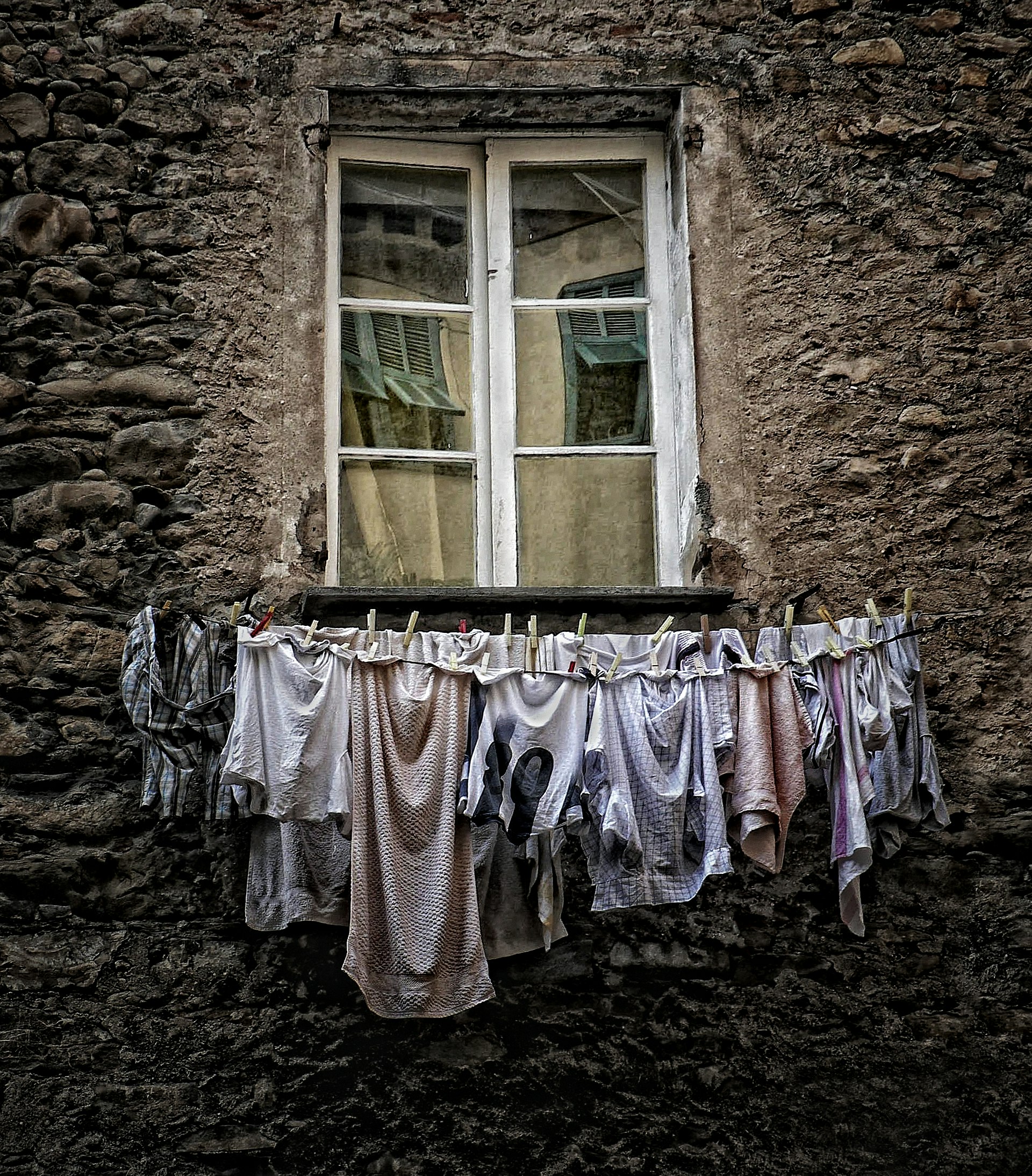assorted clothes hanged under the window